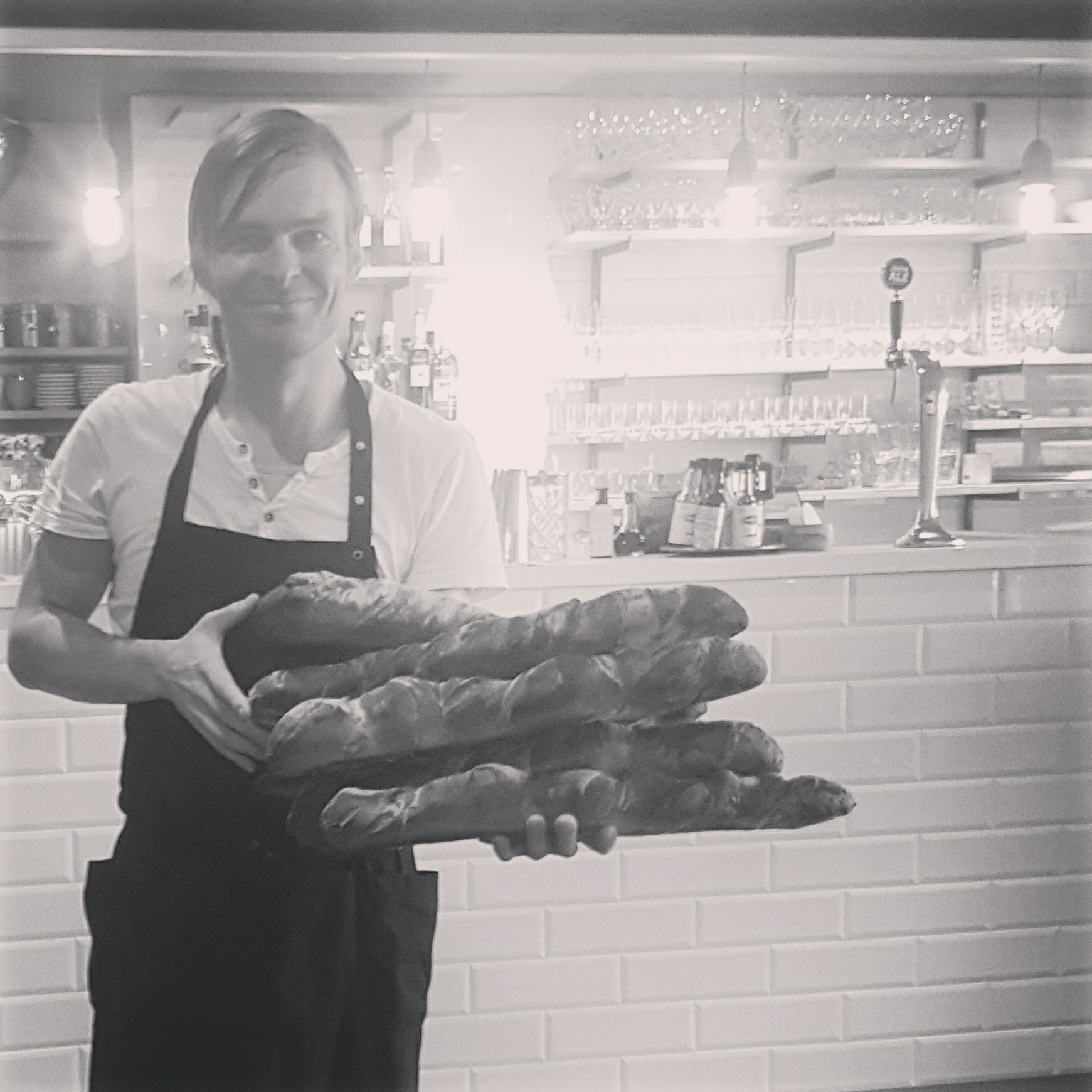 Holding freshly baked baguettes at Sinne restaurant